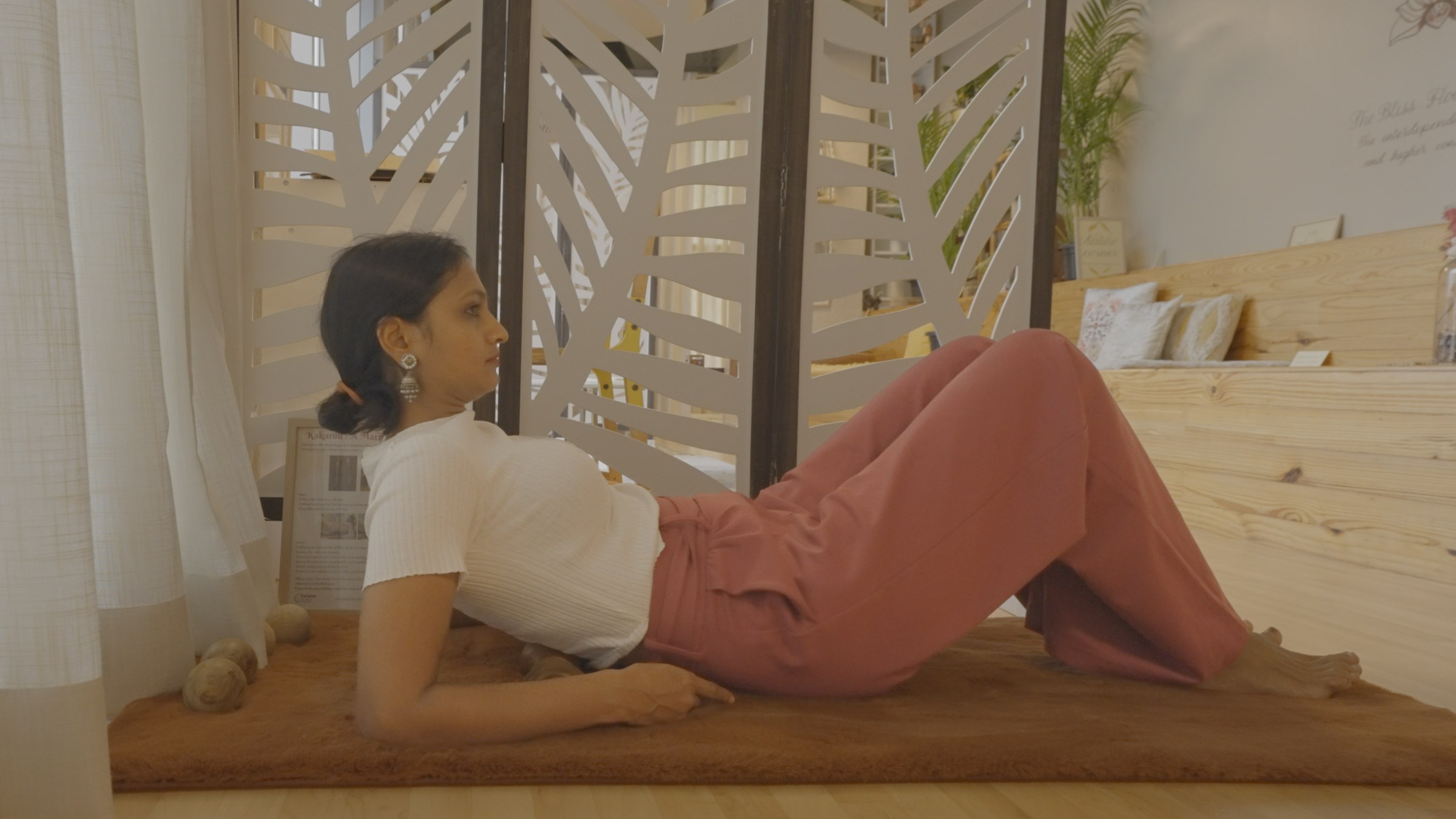 Employee stretching on the floor of a Zen Garden room